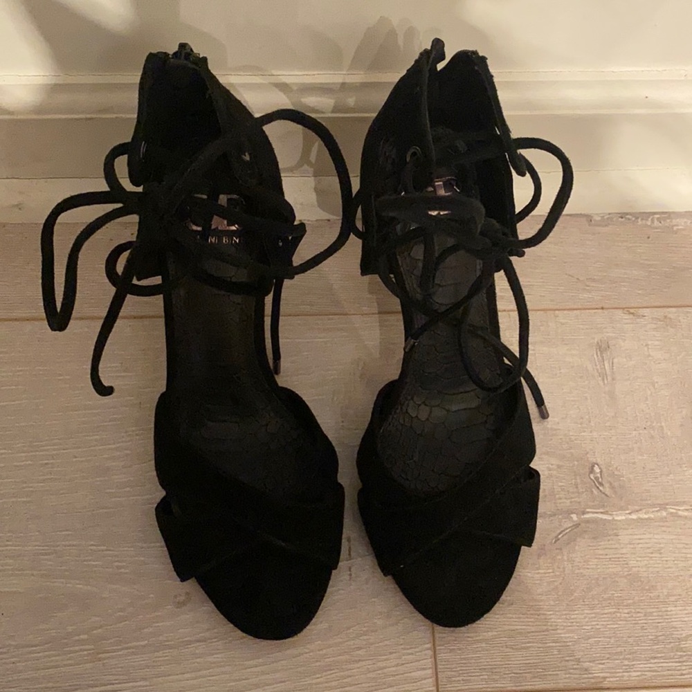 Black strap or heels, can tie into bow at the top